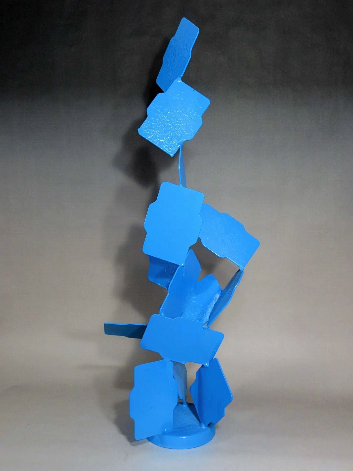 Large-scale contemporary blue steel sculpture with bold geometric composition intended to create visual identity, architectural distinction, and destination placemaking within hospitality and mixed-use developments.