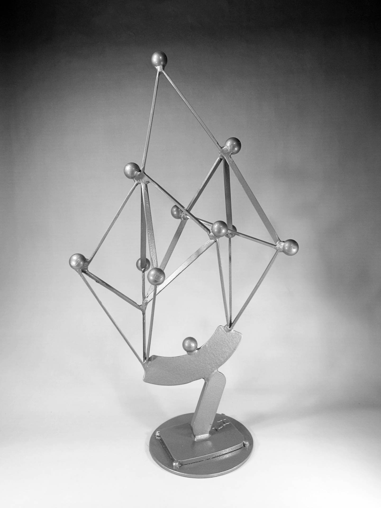 Architectural steel sculpture featuring geometric lattice construction, welded structural connections, and modern spatial composition intended for large-scale public installation.