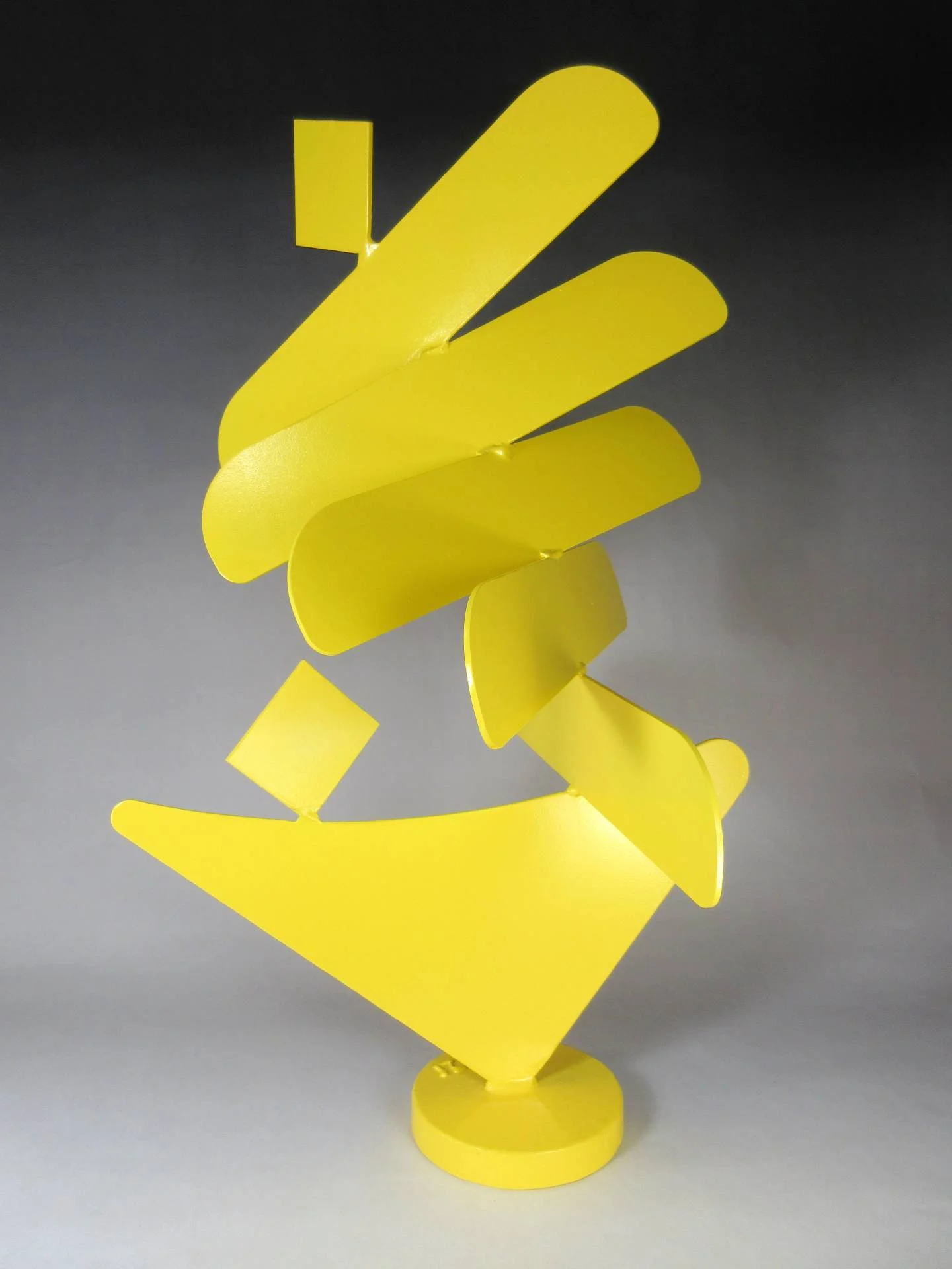 Contemporary abstract sculpture combining geometric balance, directional movement, and bold industrial color within a refined modernist composition.