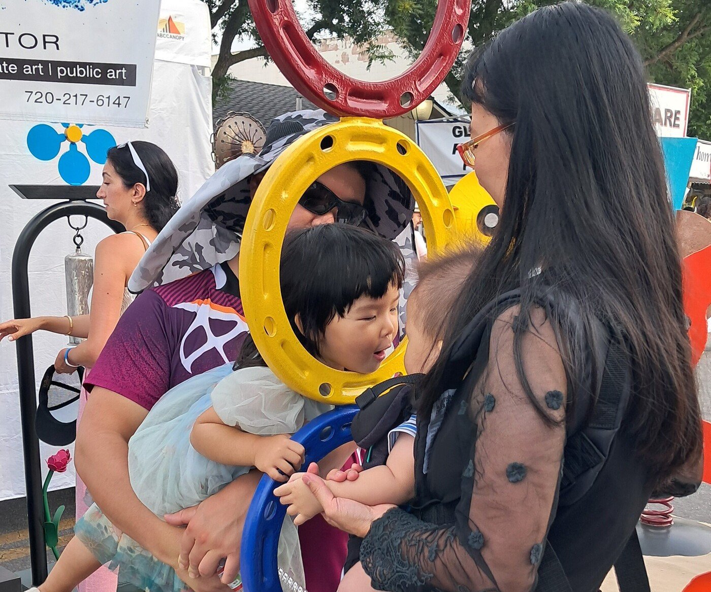 Families and children interacting with Michael Herold public sculpture at a live art festival, demonstrating community engagement, curiosity, and shared public experience.