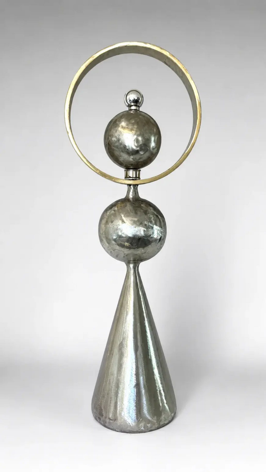 Cone Series sculpture by Michael Herold featuring stacked steel spheres contained within a circular halo form above a cone foundation, designed as a monumental landmark sculpture for civic environments, corporate campuses, hospitality developments, and architectural settings.
