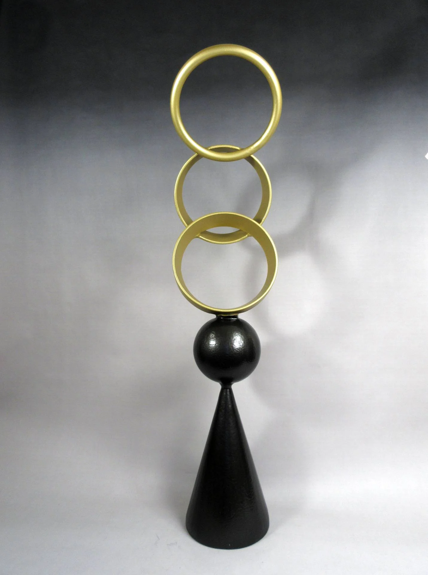 Cone Series sculpture by Michael Herold featuring nested steel spheres contained within a circular halo form above a cone foundation, designed as a monumental public art concept for civic plazas, corporate campuses, hospitality developments, parks, and architectural environments.