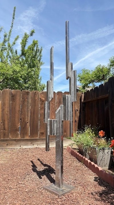 Original Skyward stainless steel sculpture by Michael Herold exploring vertical elevation, proportion, and monumental landmark design.